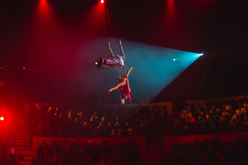 performance of aerialists in the circus arena.