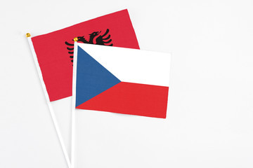 Czech Republic and Albania stick flags on white background. High quality fabric, miniature national flag. Peaceful global concept.White floor for copy space.