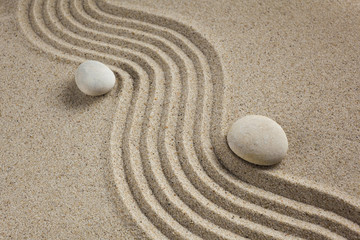 zen garden stones in light sand for relaxation and concentration during meditation