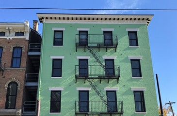 Pale Green Brick Building With Metal Fire Escape