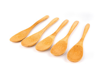 Five shallow bamboo spoons in a row