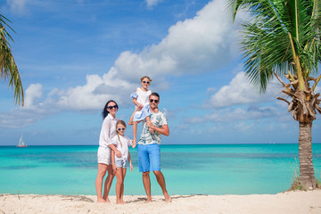 Happy beautiful family with kids on the beach