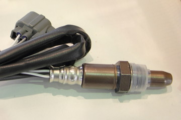 New lambda sensor close up on white background, car injector engine exhaust emission control repair