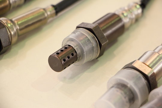 New lambda sensor close up on white background, car injector engine exhaust emission control repair