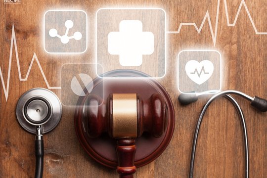 Gavel And Stethoscope On Wooden Background, Symbol Photo For Bungling And Medical Error