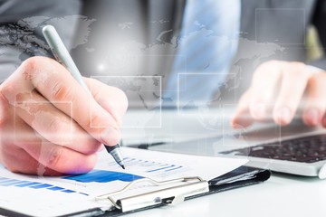 Close-up of Businesswoman makes a note at business document