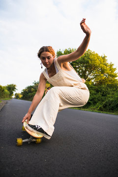 Young Woman Skateboarding in Summer