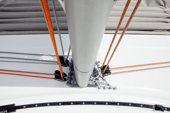 Ropes on blocks at the bottom of a mast on a cruising catamaran