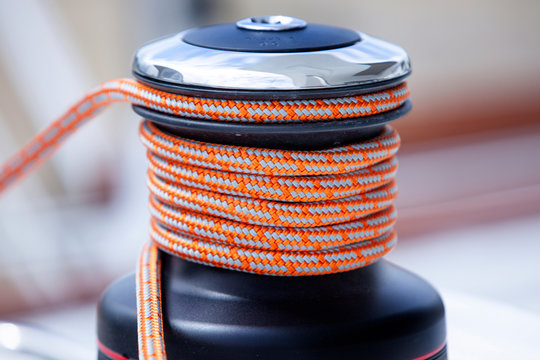 Ropes wrapped around a winch on the deck of a cruising catamaran