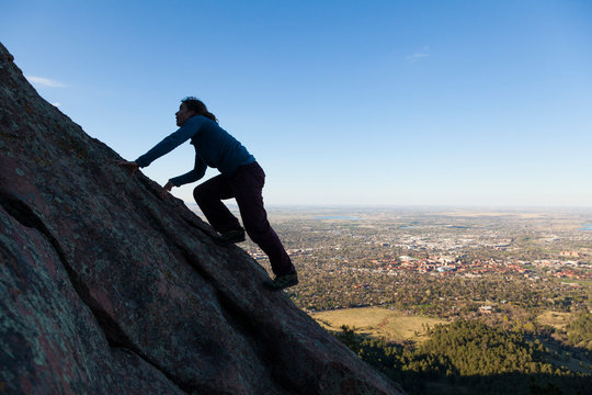 Woman climbs Second Flatiron without rope above Boulder, Colorado