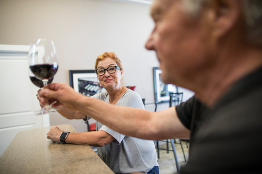 Couple cheers during a wine tasting at a local vineyard.