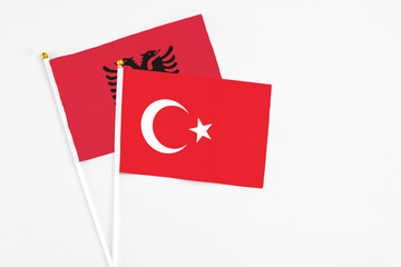 Turkey and Albania stick flags on white background. High quality fabric, miniature national flag. Peaceful global concept.White floor for copy space.