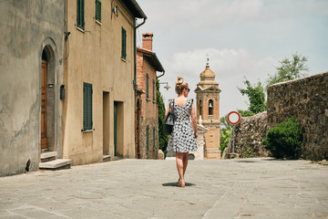 Woman walking along old streets to chapel