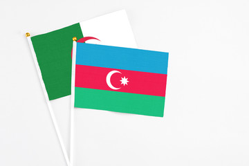 Azerbaijan and Algeria stick flags on white background. High quality fabric, miniature national flag. Peaceful global concept.White floor for copy space.