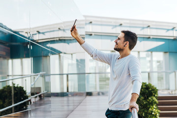 Smiling young bearded man a selfie in the city at Spain- Barcelona