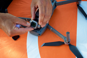 Close-up of a man preparing a drone to fly.