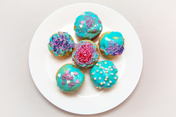 Homemade cupcakes with colorful icing on a plate