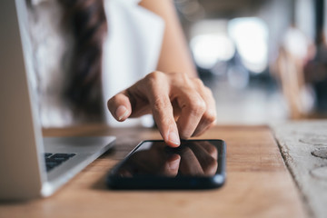 Close up woman hand press on mobile phone.