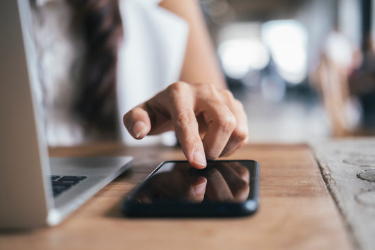 Close up woman hand press on mobile phone.