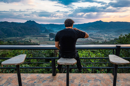 Man drinking coffee at Magic Mountain / Phayao District in North Thail