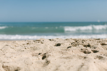 beaches sand in focus ocean view and waves summer day