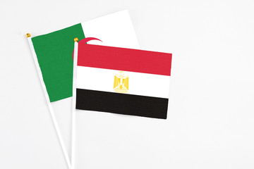 Egypt and Algeria stick flags on white background. High quality fabric, miniature national flag. Peaceful global concept.White floor for copy space.