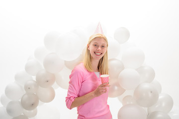 Fototapeta na wymiar Balloon. Party mood. Beautiful girl in birthday hat with balloons. Girl in pajama celebrate pajama party. Smiling woman in party balloons. Happy birthday celebration. Party celebration with balloons.