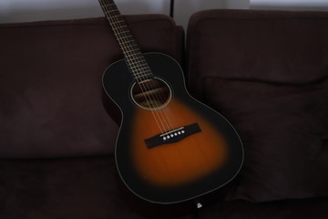 acoustic guitar on a sofs