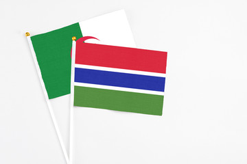 Gambia and Algeria stick flags on white background. High quality fabric, miniature national flag. Peaceful global concept.White floor for copy space.