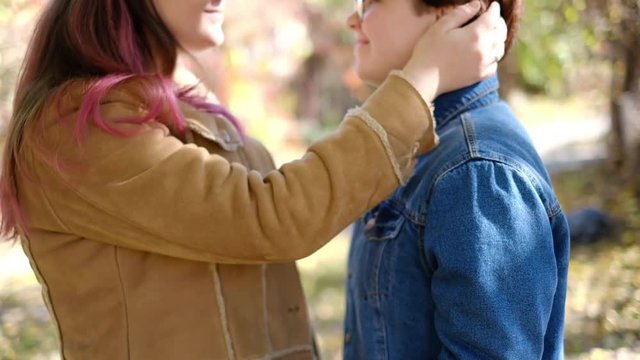 Charming young women kissing gently loving each other stroking touching face skin enjoying romantic tender moments on picnic date in the countryside.
