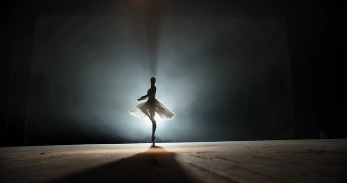 Creative female choreographer setting a ballet performance, dancing and doing various moves on spotted stage - arts concept 4k footage