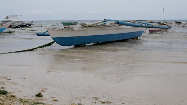 Daytime shot with overcast sky of small fishing boats in the Philippines.