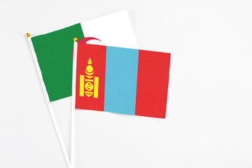Fototapeta premium Mongolia and Algeria stick flags on white background. High quality fabric, miniature national flag. Peaceful global concept.White floor for copy space.