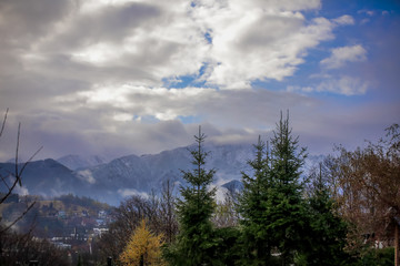 HDR photo of the Tatra Mountains and Great Giewont Peak with the steel Cross between clouds.