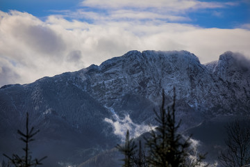 Fototapeta premium HDR photo of the Tatra Mountains and Great Giewont Peak with the steel Cross between clouds.