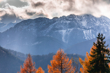 HDR photo of the Tatra Mountains and Great Giewont Peak with the steel Cross between clouds.