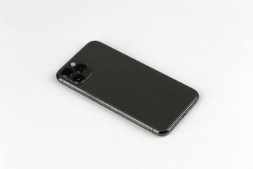 Smartphone on a white background. Smartphone with three cameras close-up.
