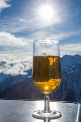 Glass of beer with the Serre Chevalier Alps in the background, France