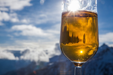 Glass of beer with the Serre Chevalier Alps in the background, France