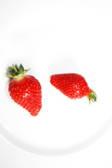 Fresh strawberries isolated on the white plate.