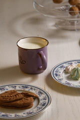 cup of milk and cake on wooden table