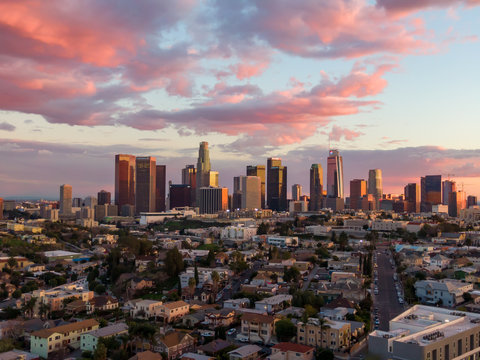 Drone shot from above of downtown Los Angeles city skyline and skyscraper buildings during golden hour