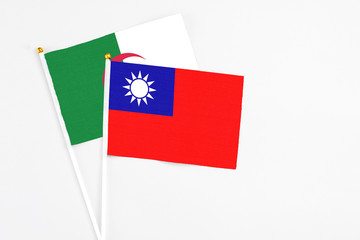 Taiwan and Algeria stick flags on white background. High quality fabric, miniature national flag. Peaceful global concept.White floor for copy space.