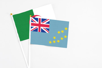 Fototapeta premium Tuvalu and Algeria stick flags on white background. High quality fabric, miniature national flag. Peaceful global concept.White floor for copy space.