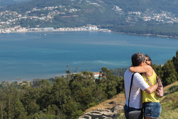 Fototapeta premium couple kissing on vacation in Galicia, in front of Miño