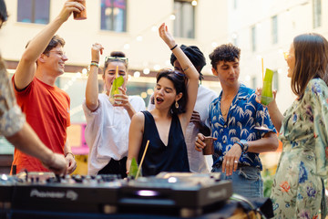 Happy multi-ethnic friends having fun during a party