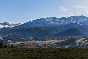 HDR photo of the Tatra Mountains and Great Giewont Peak with the steel Cross between clouds.