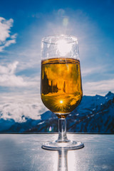 Glass of beer with the Serre Chevalier Alps in the background, France