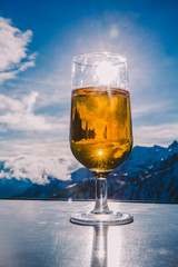 Glass of beer with the Serre Chevalier Alps in the background, France