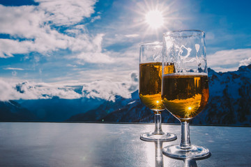 Glass of beer with the Serre Chevalier Alps in the background, France
